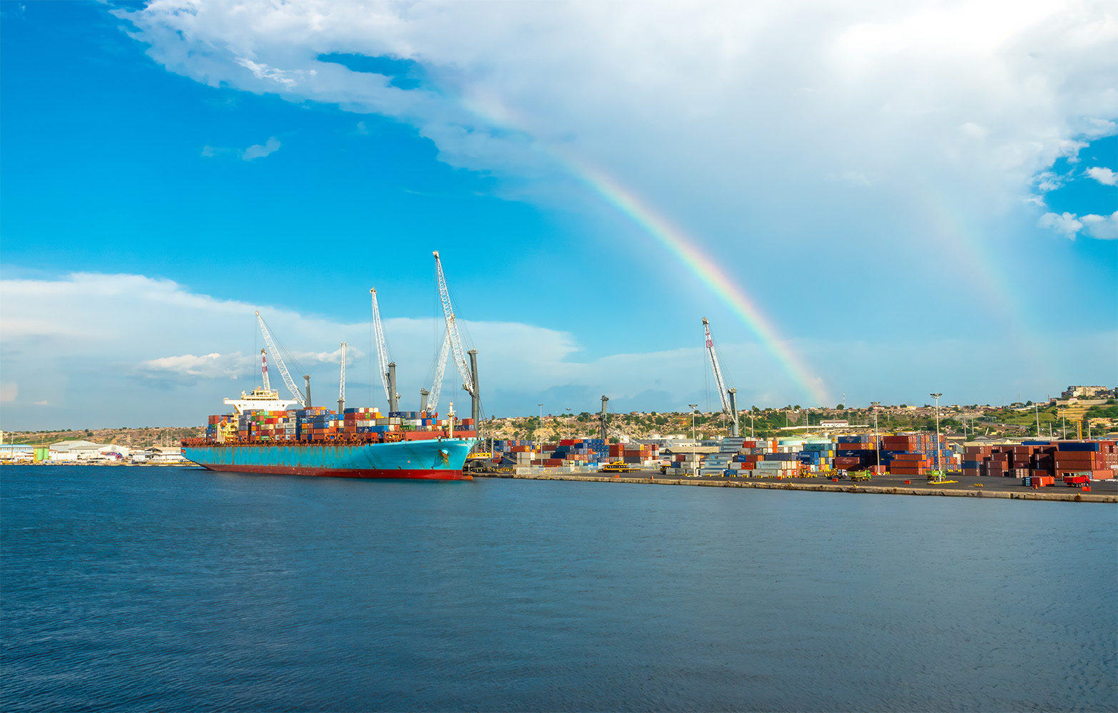 Shipping port with a rainbow